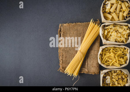 Various pasta in bag with space for your text , flat lay image Stock Photo