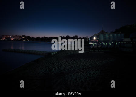 Long exposure of a city lake just after sunset. Stock Photo