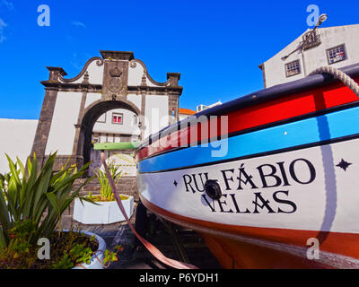 Portugal, Azores, Sao Jorge, Velas, Boat and the Portao do Mar in the harbour. Stock Photo