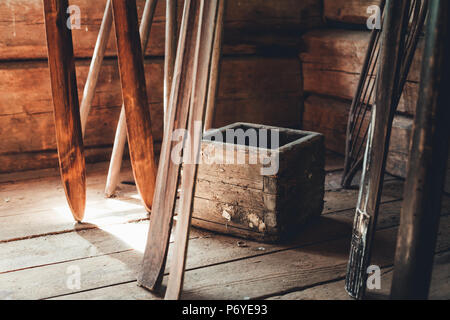 Rustic potato box and wooden skis in front of weathered girder walls Stock Photo