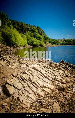 Swinsty Reservoir, Harrogate, North Yorkshire: The ongoing heatwave in the UK is causing the water levels in the reservoirs to drop. Credit: Caught Li Stock Photo