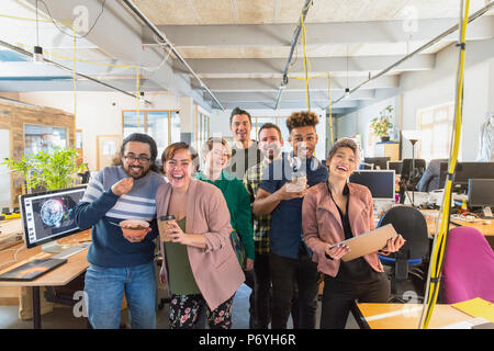 Portrait happy, playful creative business team in open plan office Stock Photo