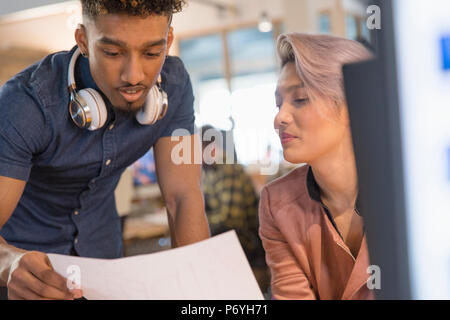 Creative business people discussing paperwork in office Stock Photo