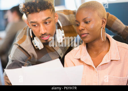 Focused creative business people reviewing paperwork Stock Photo