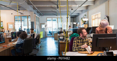 Creative business people working in open plan office Stock Photo