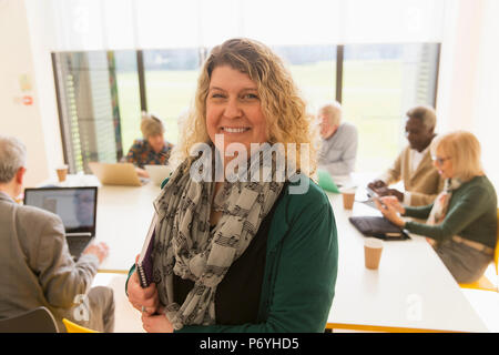 Portrait smiling, confident businesswoman leading conference room meeting Stock Photo