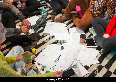 Creative business people meeting, brainstorming in circle on floor Stock Photo