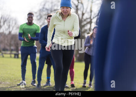 Determined senior woman exercising in park Stock Photo