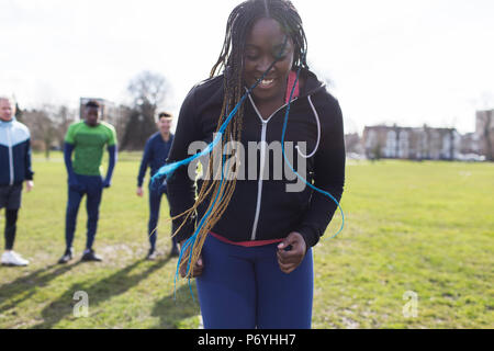 Smiling woman exercising in park Stock Photo