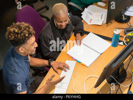 Creative business people working, meeting at computer in office Stock Photo