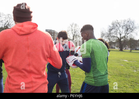 Men boxing in park Stock Photo