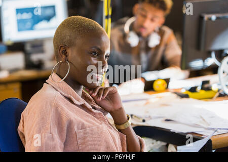 Smiling creative businesswoman working in office Stock Photo