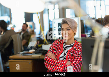 Smiling, confident creative businesswoman working in office Stock Photo