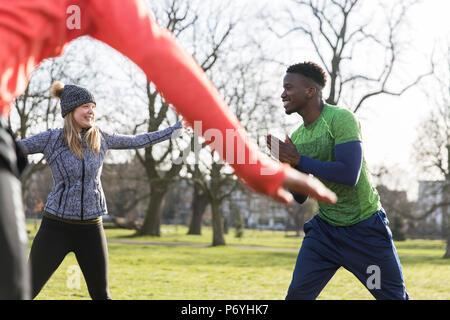 People exercising, stretching in park Stock Photo