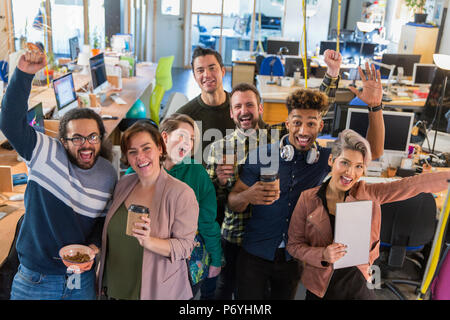 Portrait enthusiastic creative business team cheering Stock Photo
