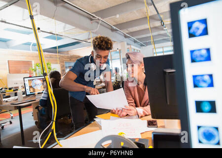 Creative business people discussing paperwork in office Stock Photo