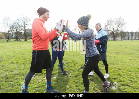 People boxing in park Stock Photo