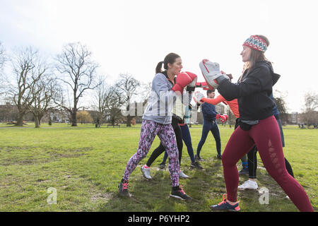 Women boxing in park Stock Photo