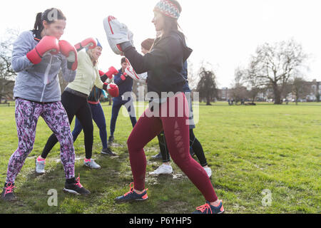 Women boxing in park Stock Photo