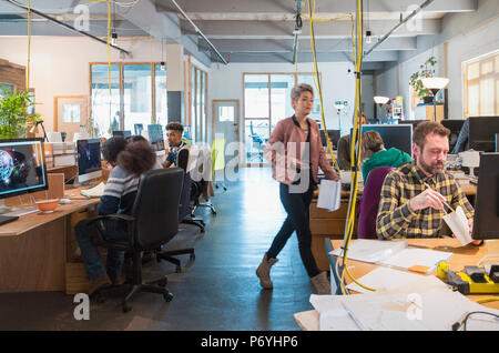 Creative business people working in open plan office Stock Photo