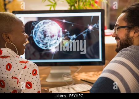 Designers meeting, working at computer in open plan office Stock Photo
