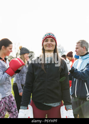 Portrait confident woman boxing in park Stock Photo