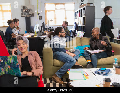 Creative business people meeting and working in casual, open plan office Stock Photo