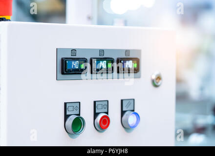 Temperature control panel cabinet contain digital screen display for temperature gauge. green, red, and white button for open, shutdown, and adjust ma Stock Photo