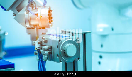 Robot hand machine gripping simulated  object on blurred background. Use smart robot in manufacturing industry. Robotic tool in factory. Robot enginee Stock Photo