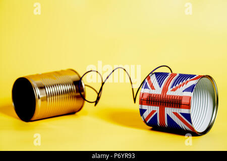 tin can phone with British flag.communication concept on yellow Stock Photo