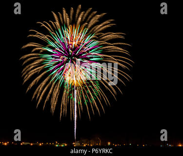 Fireworks - 5 colorful bursts within bursts with rocket trail from the ground. Stock Photo