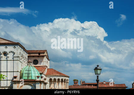 Beautiful clouds above Lucca historic center with cathedral apse and Guinigi medieval tower (with copy space) Stock Photo
