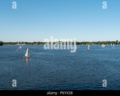 Hamburg, Germany - July 02, 2018: People enjoy the fine weather at Alster Lake in Hamburg Germany joining a Regatta. Stock Photo