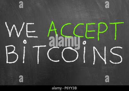 We accept bitcoins chalk text written on blackboard or chalkboard as cryptocurrency virtual payment concept Stock Photo