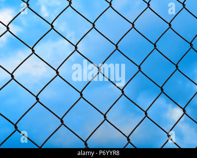 Net metallic pattern barrier against blue sky Stock Photo