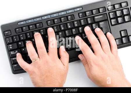 Top view of businessman hands typing black desktop wireless computer keyboard Stock Photo