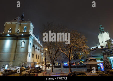 LVIV, UKRAINE - FEBRUARY 04, 2018: Beautiful night winter cityscape in the center of Lviv city. Some lens flare flrom lamps available. Stock Photo