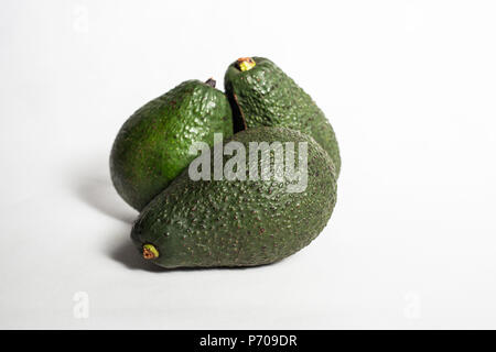 Avocados Isolated on white background in a group stack dark green Stock Photo