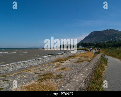 Looking along to Llanfairfechan sea front to the Beach Pavilion Cafe from the North Wales Coastal Path on a lovely June day Stock Photo