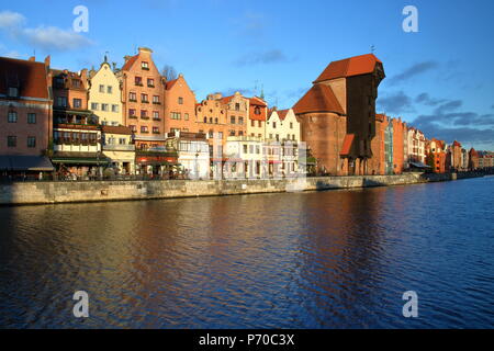 Historical downtown in Gdansk, Poland, river Motlava embankment, beautiful architecture, medieval crane, sunny weather, blue sky Stock Photo