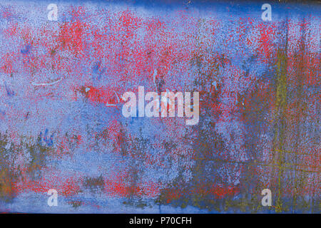 Background of rusty, red, blue and yellow coloured metal surface. Stock Photo