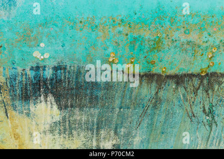 Background of rusty,turquoise, black, blue and yellow colored metal surface. Stock Photo