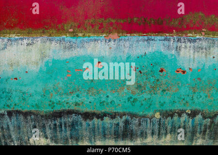 Background of rusty, red, blue, turquoise, black and yellow colored metal surface. Stock Photo