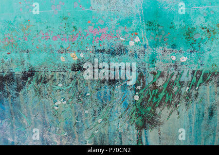 Background of rusty, pink, green, blue, black and turquoise coloured metal surface. Stock Photo
