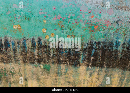 Background of rusty, turquoise, blue, black, pink and yellow coloured metal surface. Stock Photo