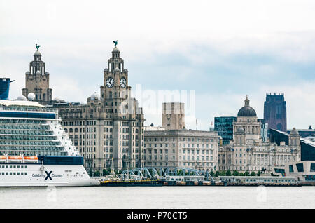 View of clock towers of Royal Liver building with Liver Birds and UK's largest clocks, Celebrity Cruise ship, Pier Head, Liverpool, England, UK Stock Photo