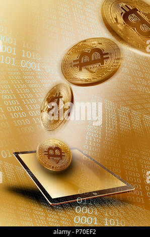 Golden Bitcoins over digital tablet Stock Photo