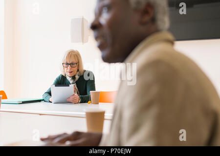 Senior businesswoman using digital tablet in conference room meeting Stock Photo