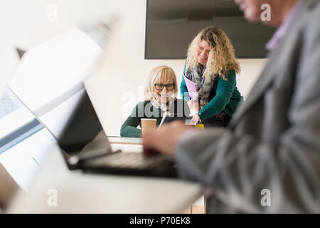 Businesswomen using digital tablet in conference room meeting Stock Photo