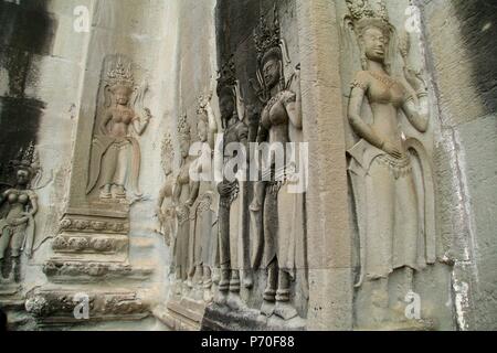 Intricate stone carvings on the walls of a Buddhist Temple in Cambodia Stock Photo